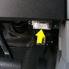 vehicle interior showing OBD2 port with a yellow arrow - chip your car performance chips