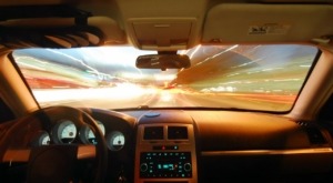 interior of vehicle driving through city at night - chip your car performance chips