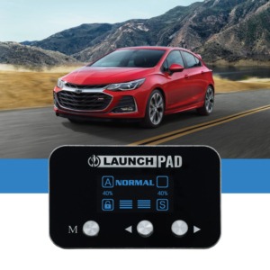 red Chevy car driving near mountain - chip your car performance chips