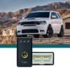 white Dodge SUV near houses - chip your car performance chips