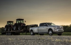 silver Dodge Ram truck hauling tractors - chip your car performance chips
