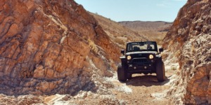 jeep driving through desert rock - chip your car performance chips