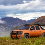 orange truck in between two mountains - chip your car performance chip