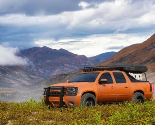 orange truck in between two mountains - chip your car performance chip