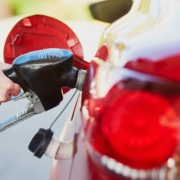 person pumping gas into red car - chip your car performance chip