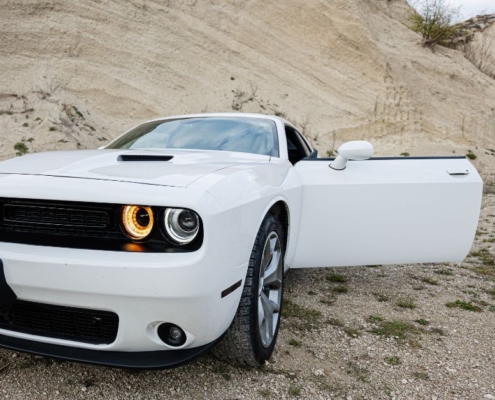 white Dodge car sitting near a hill - chip your car car tuner